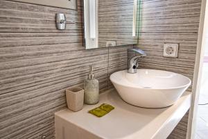 纳乌萨米卡别墅酒店的浴室设有白色水槽和镜子