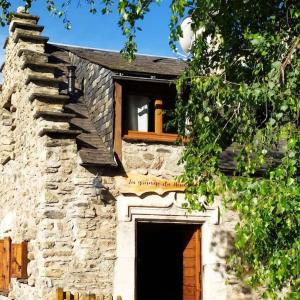 圣拉里苏朗La grange du hameau的一座石头建筑,设有窗户和门