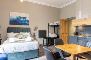 爱丁堡MONO Suites NEW TOWN的卧室配有一张床和一张桌子及椅子