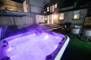 巴克斯顿Foxlow Grange By Muse Escapes的教堂庭院内的紫色浴缸