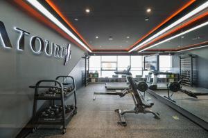 邯郸邯郸新世纪亚朵酒店的一个带有氧器材的健身房,位于一个墙上
