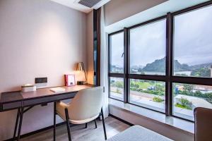 肇庆肇庆七星岩亚朵酒店的一张位于带大窗户的客房内的桌子