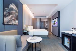 深圳深圳华强北商业中心亚朵酒店的酒店客房设有床和客厅。