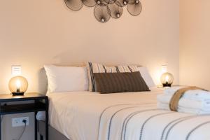 帕伦西亚INSIDEHOME Apartments - La Casita de Montse的一间卧室配有一张床和两张台灯。