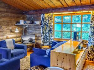 尼尔西艾Holiday Home Kelosyväri 17 by Interhome的客厅配有蓝色的椅子和木桌