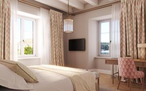 察夫塔特Hotel Supetar的卧室配有一张床、一张书桌和窗户。
