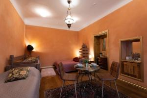 里加两轮酒店的客厅设有橙色墙壁和桌椅
