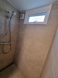 伦讷Slottets Anneks的带淋浴的浴室和窗户。