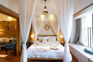 重庆重庆森林逸居民宿的卧室配有带白色窗帘的天蓬床