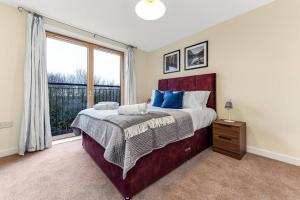米尔顿凯恩斯Scenic Park View Suite的一间卧室设有一张大床和一个窗户。
