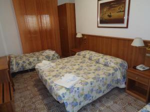 丘西罗萨蒂酒店的一间酒店客房内设有两张床的房间