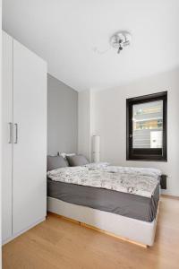 奥斯陆Modern 3bed room sea view apartment @ Oslo Barcode的白色卧室配有床和镜子