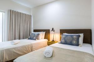 赫斯基森Ishtar Apartment 2- Luxury Living Accommodation的一间卧室设有两张床和窗户。
