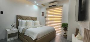 安吉利斯CozyNest - Modern 1 Bedroom Gem Luxury Smart Unit的一间卧室设有一张大床和一个窗户。