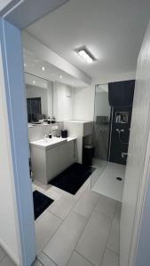 韦瑟灵Luxus Wohnung Köln/Phantasialand/Bonn/ Messe的白色的浴室设有水槽和淋浴。