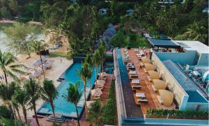 拉扬海滩度Anantara Layan Phuket Resort的享有带游泳池和海滩的度假村的空中景致