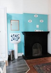 开普敦Ben Your Friend Youth Foundation的一间带蓝色墙壁和壁炉的浴室
