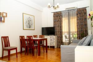 雅典Athens Quality Apartments - No4 - 1-bedroom apartment的客厅配有桌椅和电视。