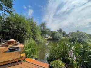 Horní PodlužíGlamping Jedlova - Romantic and family getaway的木甲板上设有桌子和湖泊