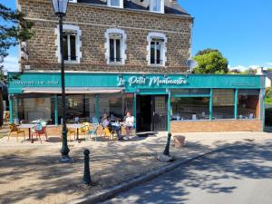 迪纳尔Le petit Montmartre的一座建筑,设有配有桌椅的餐厅