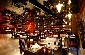 杭州杭州温德姆至尊豪廷大酒店的一间带桌椅的餐厅以及砖墙