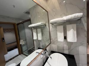 张家界Zhangjiajie lollipop Hotel的浴室配有卫生间、盥洗盆和淋浴。