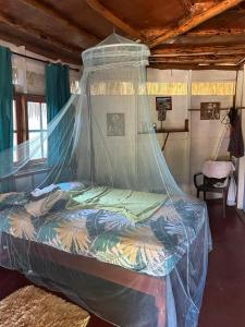Little BayLittle Bay Bungalow的一间卧室配有一张带蚊帐的床