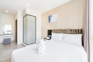 奈扬海滩Wyndham Royal Lee Phuket的卧室配有一张大白床和大镜子