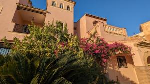 马拉加Casa Monte Victoria的一座带粉红色花卉钟楼