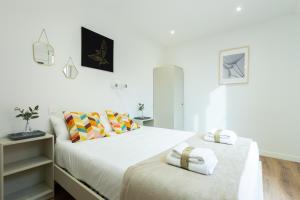 帕伦西亚INSIDEHOME Apartments - La Casita de Álex的卧室设有2张床和白色的墙壁。