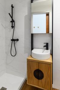波尔图Maria da SÉ Historic House的一间带水槽、镜子和淋浴的浴室