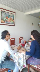 比利亚维哈Hostal Makesa Tatacoa的坐在桌子上的男人和女人