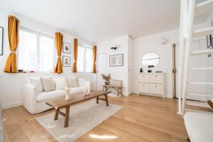 勒瓦卢瓦-佩雷Beautiful duplex on the outskirts of Paris - Welkeys的客厅配有白色的沙发和桌子