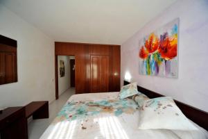 埃斯特里-德阿内乌瓦尔德阿内乌酒店的卧室配有一张床,墙上挂有绘画作品