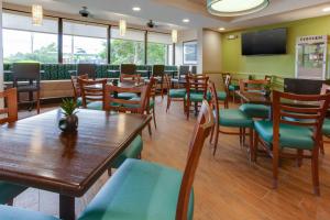 纳什维尔纳什维尔机场德鲁里套房酒店的用餐室配有木桌和椅子