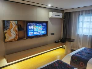 广州逸米米公寓(广州十三行一德路地铁站店)的配有电视、床和桌子的房间