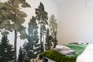 尼德根Fewo Eifel Eichen的卧室的墙上挂有森林壁画