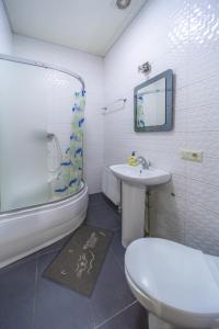 哈尔科夫Окремі номери поруч з Південним вокзалом的浴室配有卫生间、盥洗盆和淋浴。