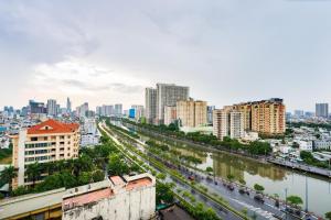 胡志明市Exclusive D1mension in District 1 3BR Apartment FreePoolSaunaGym的享有河流和建筑的城市美景