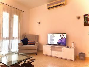 赫尔格达South marina apartment MS10 Wi-Fi available的客厅配有平面电视和椅子。