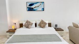 苏尔Wadi Shab Beach Villa的卧室配有白色的床和沙发