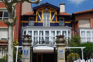 普伦西亚Casa de marinos UribeKosta的蓝色和黄色的房子,前面有门