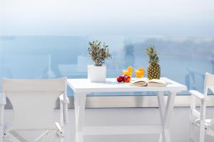 易莫洛林独特套房别墅的一张带水果的白色桌子和两把椅子