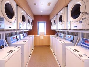 别府Beppu Hatto Onyado Nono Beppu的洗衣房配有白色的洗涤器和窗户