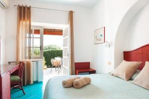 伊斯基亚波焦阿拉格斯特Spa酒店 的一间卧室配有一张床,上面有两条毛巾