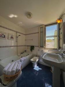 普蒂尼亚诺Dolce Farinella的带浴缸、卫生间和盥洗盆的浴室