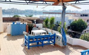 卢克索House of Dreams apartments Luxor的阳台的蓝色长椅享有水景