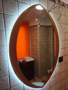 拉奎拉Appartamento Fontesecco的浴室的墙上装有椭圆形镜子