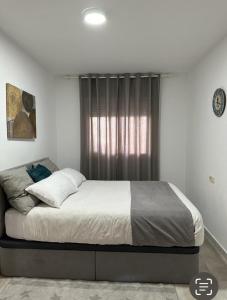 阿尔考斯布里Apartamento La Timba的卧室在窗户前配有一张大床