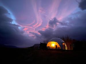霍尔斯沃德吕尔Aurora Dome on the South Coast的阴天下的一个灯光圆顶帐篷